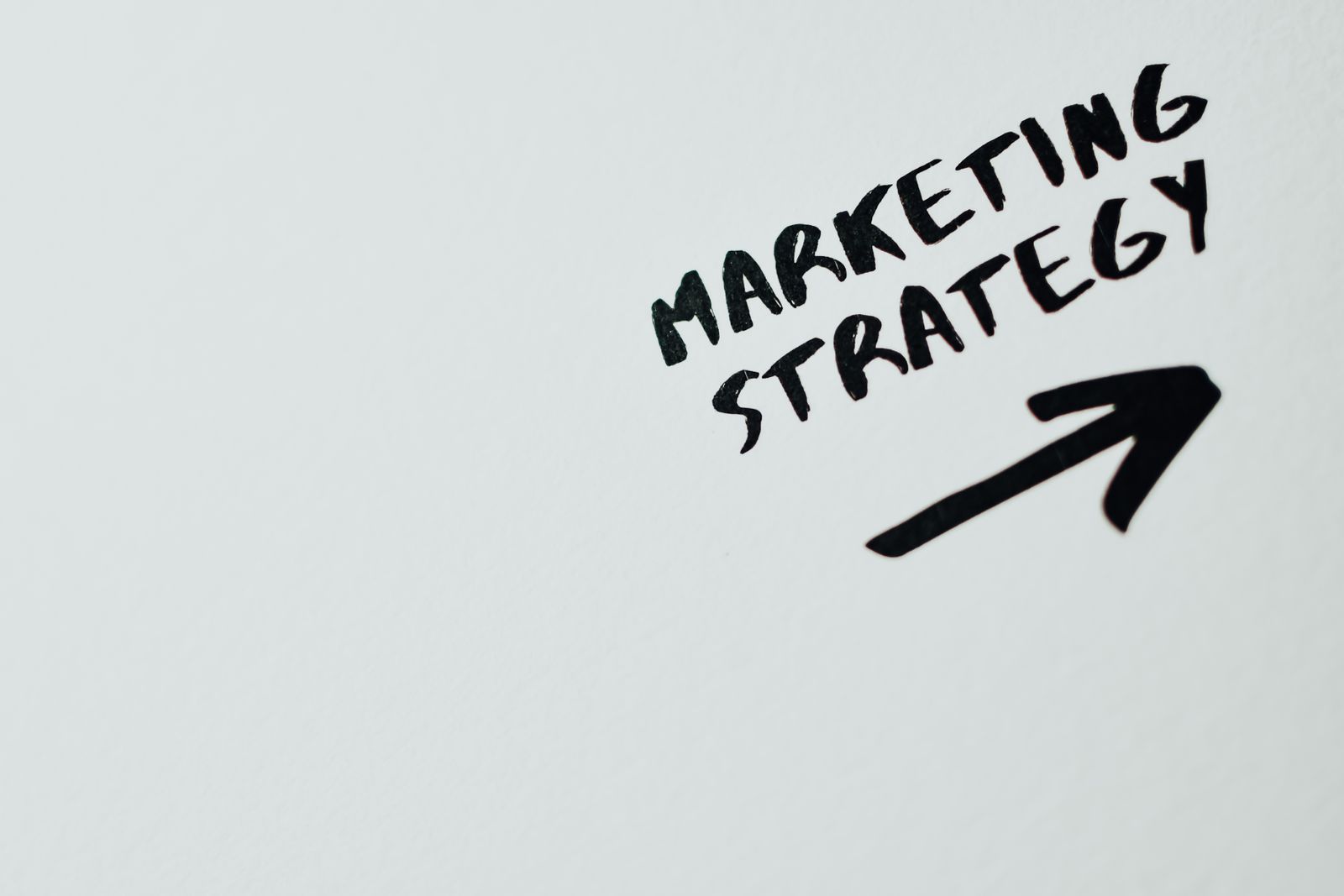 Illustrative photo of marketing strategy text on paper
