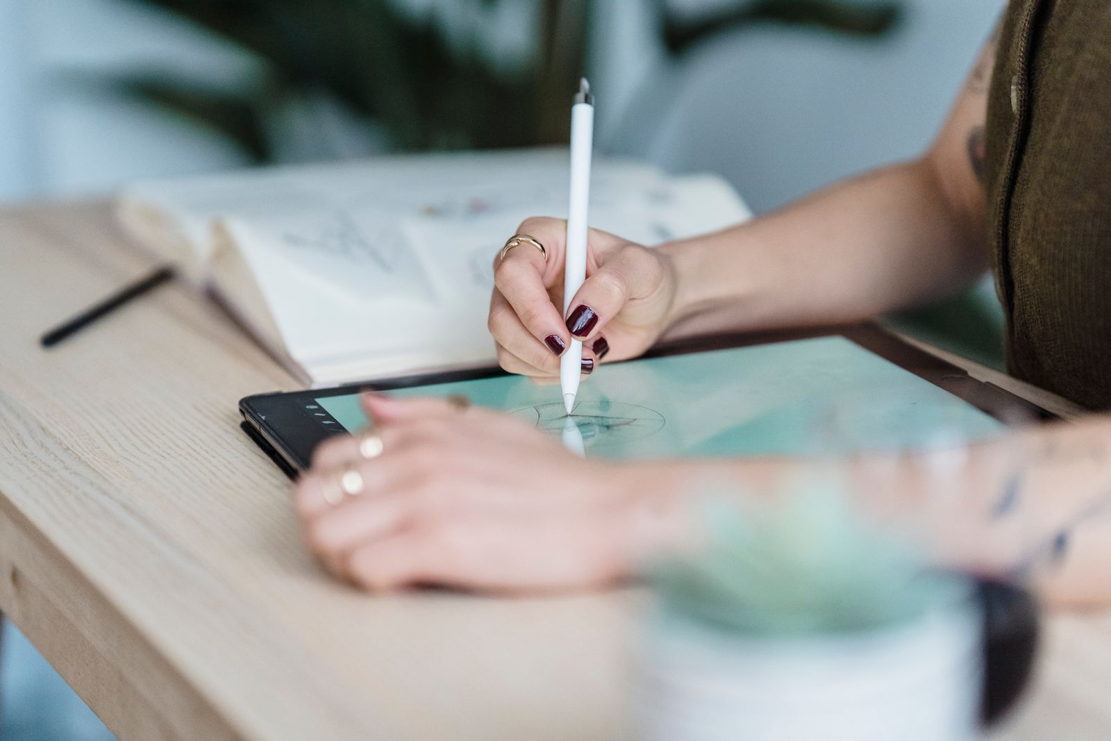 Illustrative photo of a designer drawing on a tablet