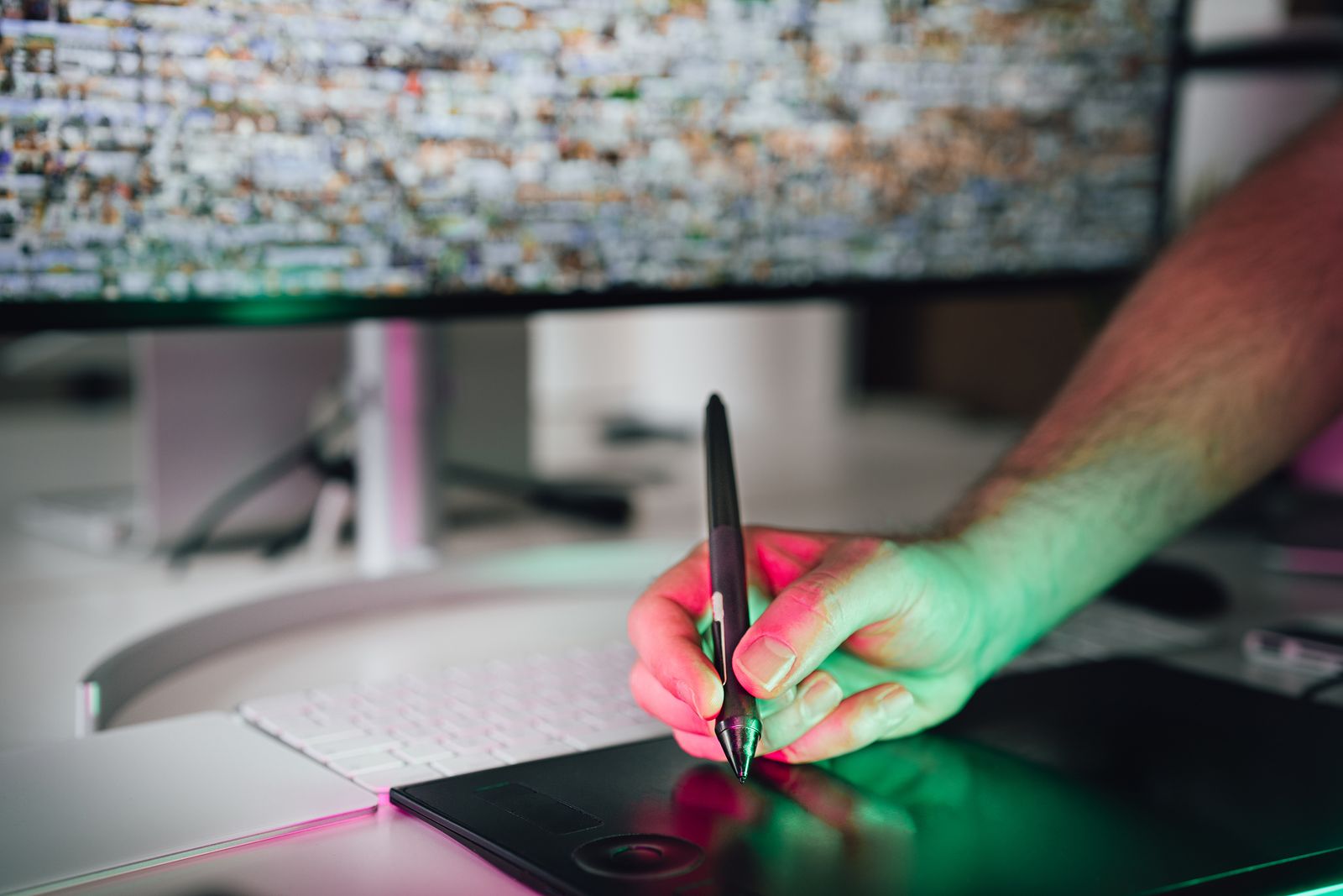 Illustrative photo of a hand drawing on a graphics tablet