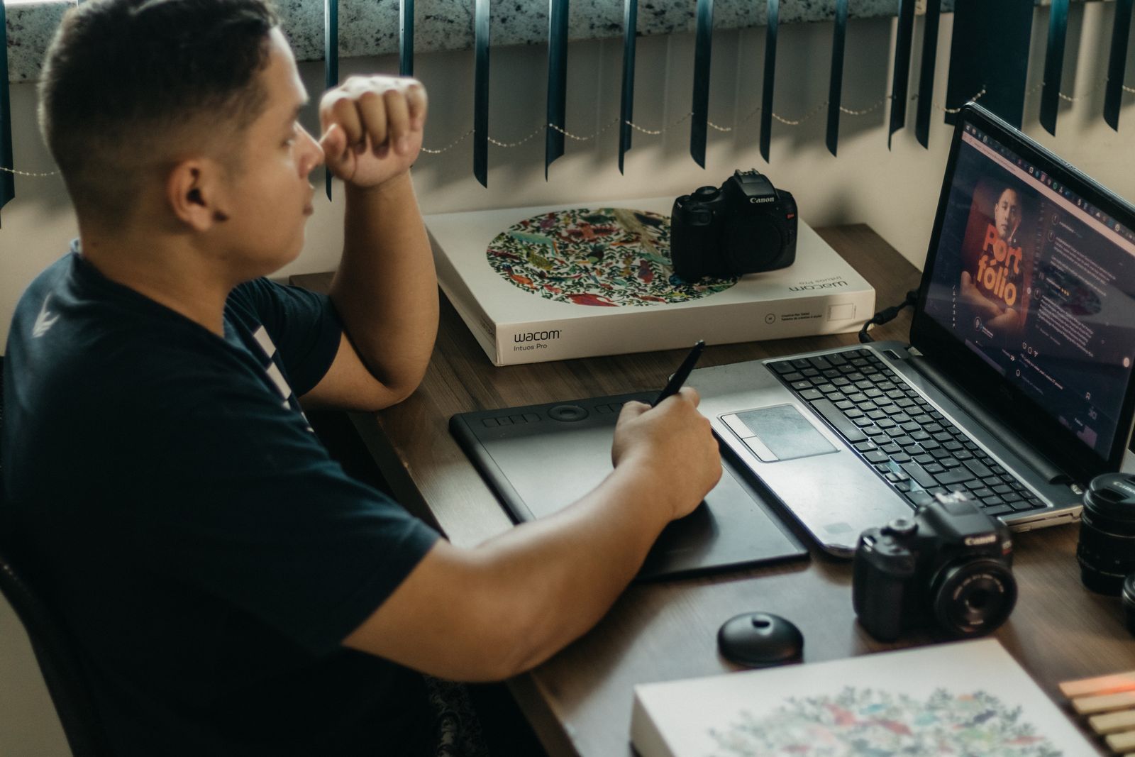 Illustrative photo of a designer working on a tablet and laptop