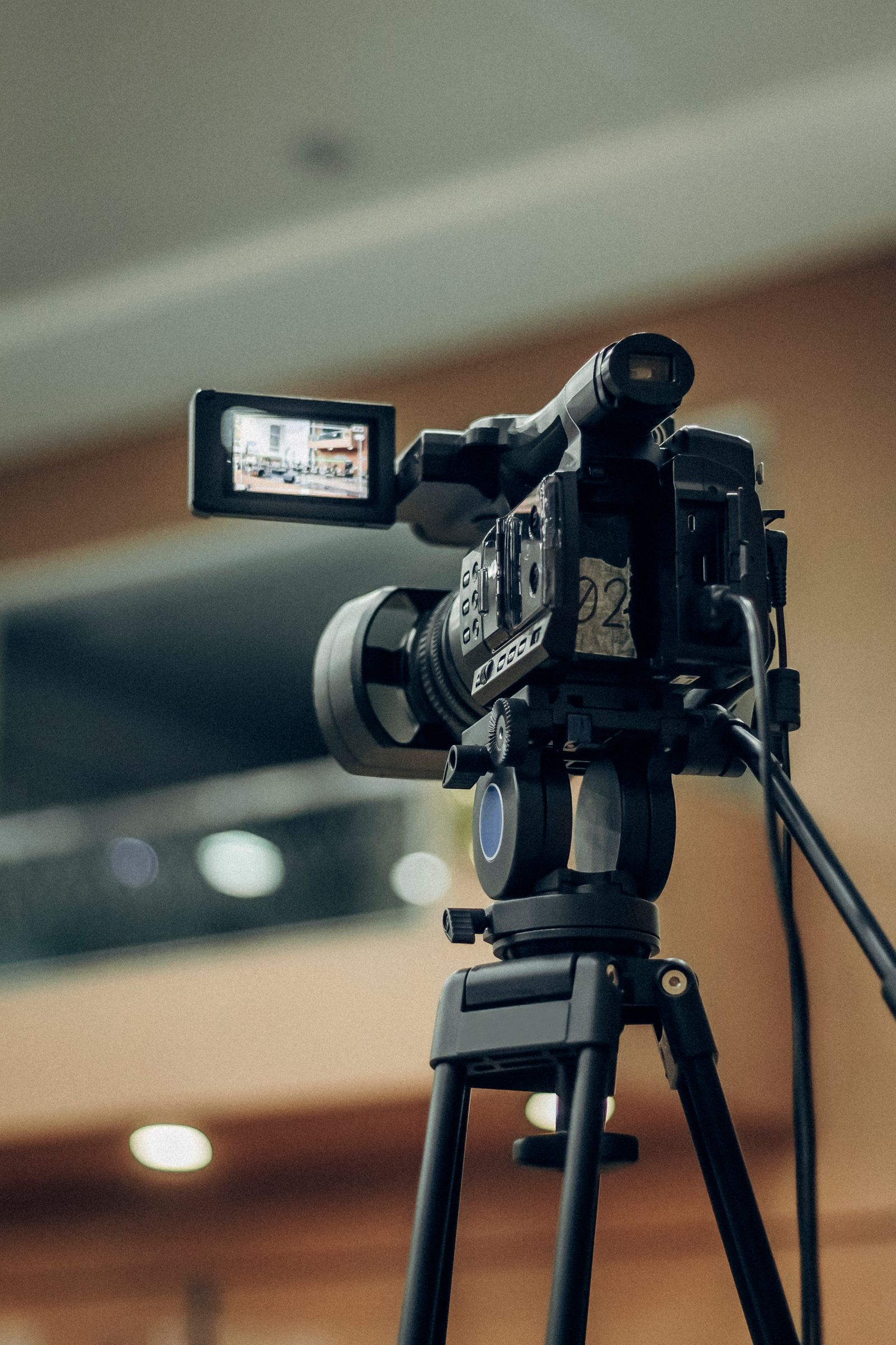Illustrative photo of a camcorder on a stand recording