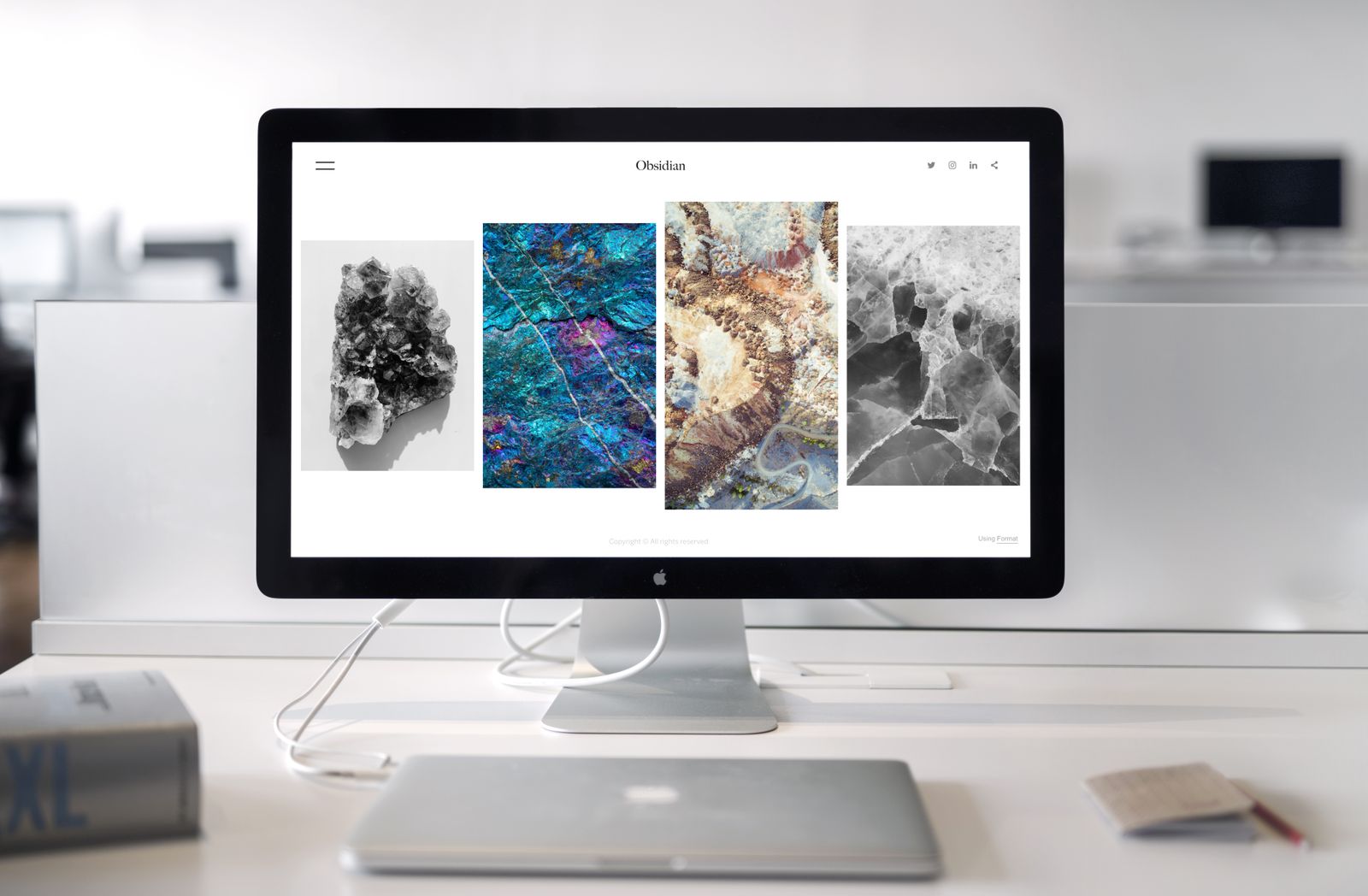 Illustrative photo of an iMac next to a MacBook on a desk